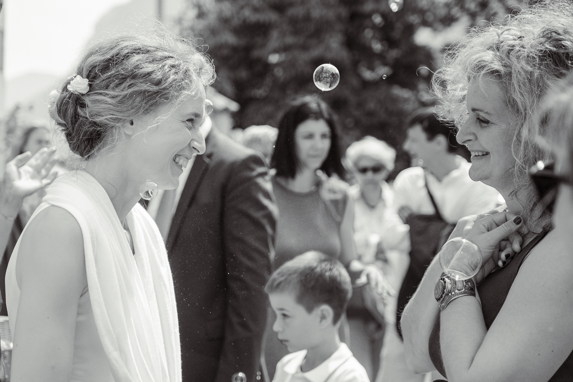 Emotionale Gratulation einer Gästin an die Braut in einer berührenden Schwarz-Weiß Aufnahme während der Hochzeit - Emotionale Gratulation einer Gästin an die Braut in Schwarz-Weiß Schwarz-Weiß Foto: Gästin umarmt die Braut bei der Hochzeit Berührender Moment zwischen Braut und Gästin in emotionaler Umarmung Hochzeitsmoment in Schwarz-Weiß: Gästin gratuliert der Braut Emotionale Szene einer Gratulation an die Braut während der Hochzeit Gästin gratuliert der Braut mit einer herzlichen Umarmung, Schwarz-Weiß Aufnahme Intimer Hochzeitsmoment zwischen Braut und Gast in Schwarz-Weiß Schwarz-Weiß Hochzeitsfoto: emotionale Gratulation an die Braut Bewegender Moment: Gästin und Braut in inniger Umarmung Emotionale Begegnung zwischen Braut und Gästin am Hochzeitstag